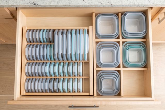 Container lids stored vertically beside nested bases